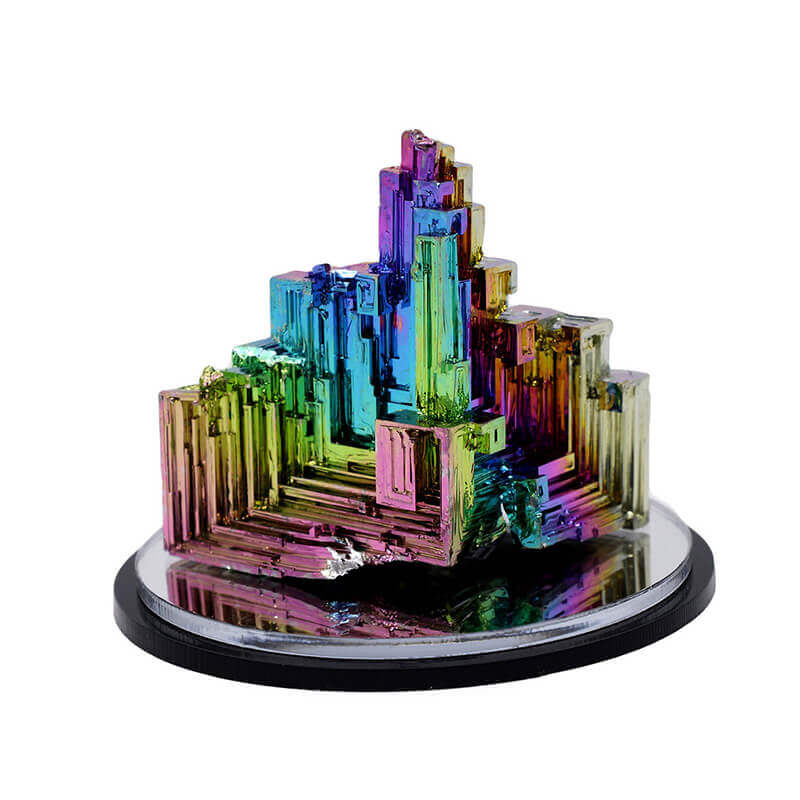 hand holding rainbow bismuth crystal